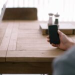 person-smartphone-office-table